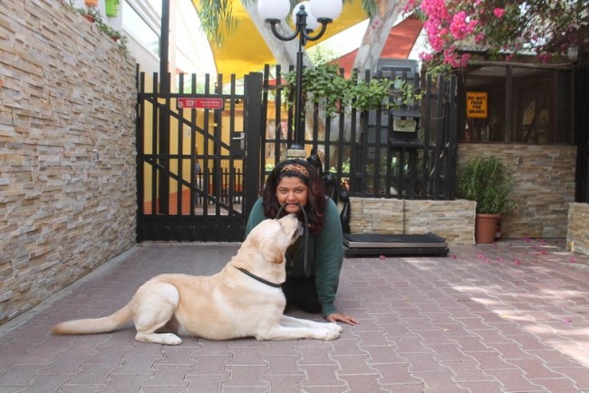 A Dog and A Woman Biting a Leash